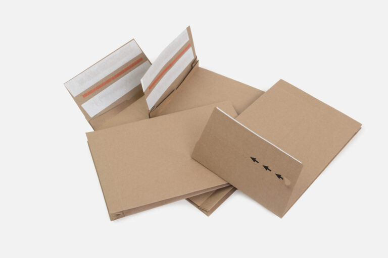 Several KRAFTMAILER® kraft paper mailing bags with adhesive strips