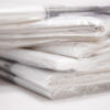 Gestapelte Textilien in ECOBAGS® Textilverpackungen aus Regranulat