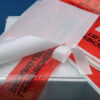 Self-adhesive document wallets in a dispenser box